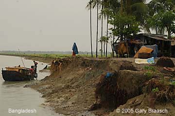 Bangladesh erosion along river cuts a town in the middle, an increasing threat from global warming.