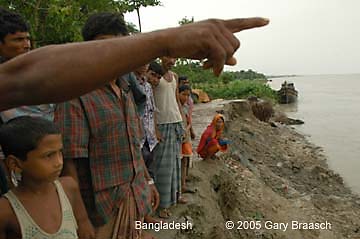 Bangladeshis point to where the town mosque stood just two months ago, as increasing river erosion is eating away at their town south of Dhaka.